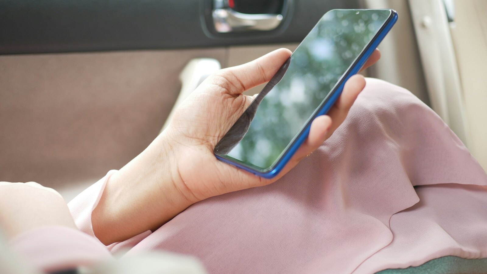 A person holding a phone at home